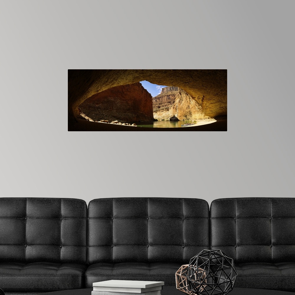 A modern room featuring Wide angle photograph, looking out of a large cave opening near the Colorado River in Arizona.  L...