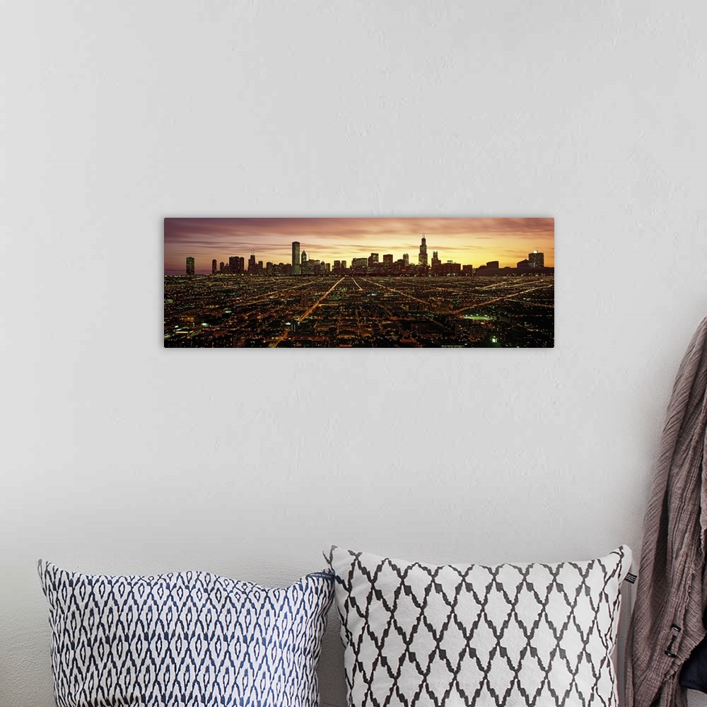 A bohemian room featuring Panoramic photograph of skyline and city lit up at sunset.