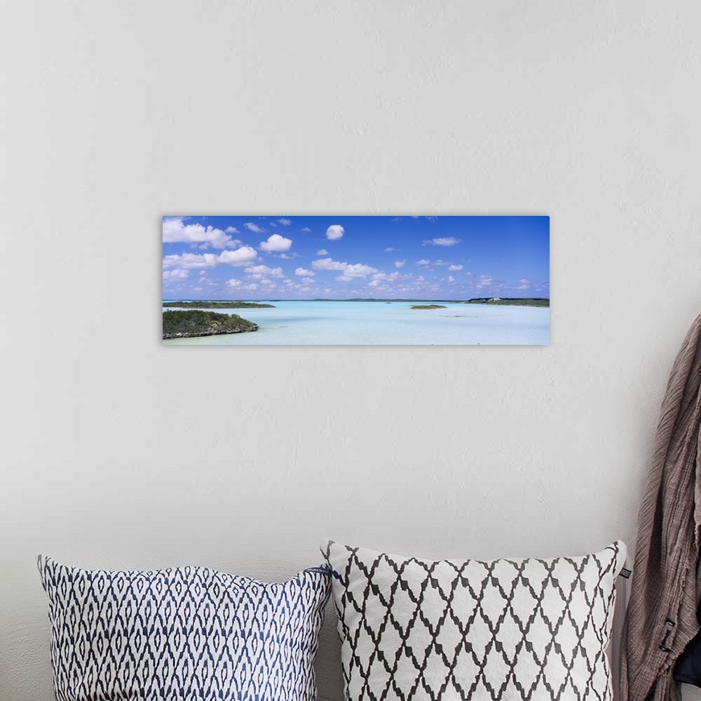 A bohemian room featuring Panoramic photograph of inlet with grass covered sand bars under cloudy skies.