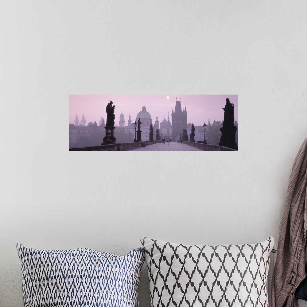 A bohemian room featuring Horizontal photo print of a bridge with people walking across amongst statues and an old town in ...