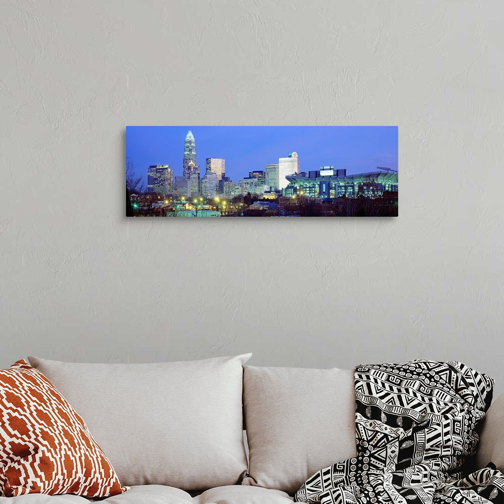 A bohemian room featuring Panoramic cityscape photograph of the Queen City downtown at twilight.