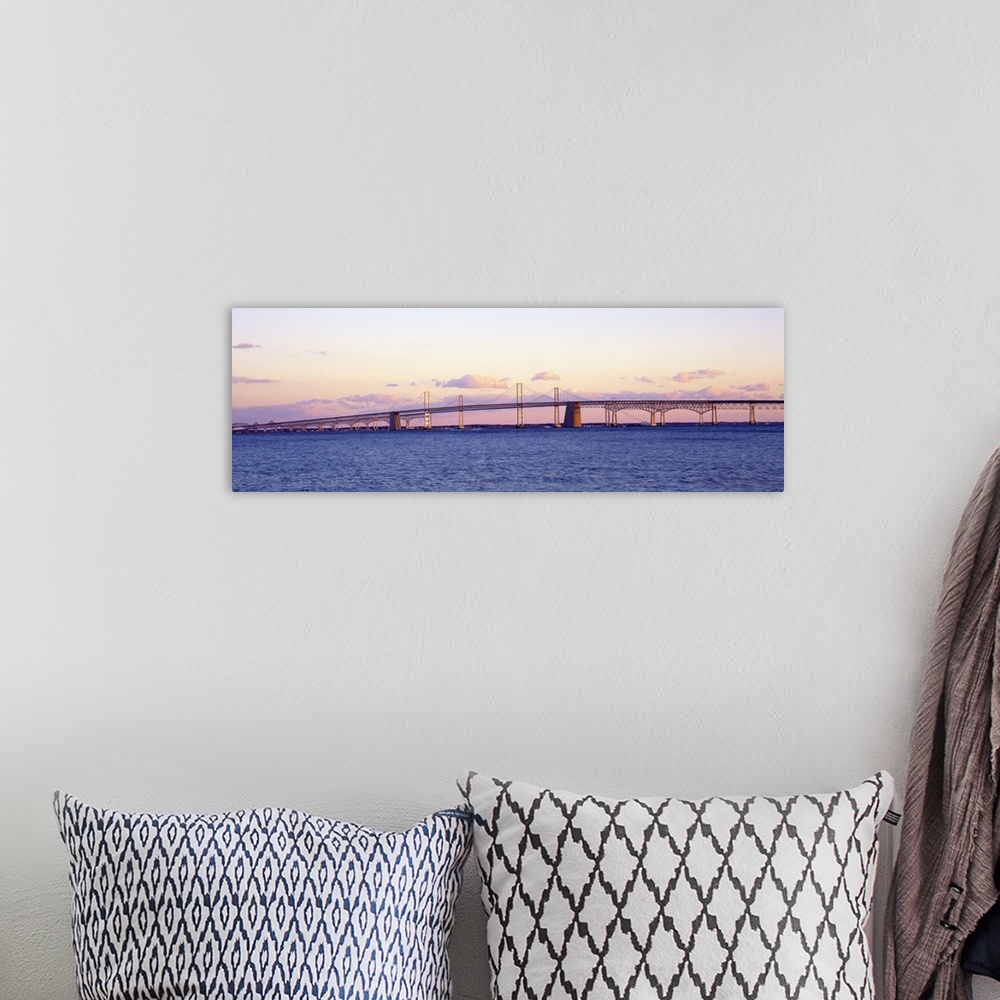 A bohemian room featuring This large panoramic shot is taken of the Chesapeake Bay Bridge during a sunset.