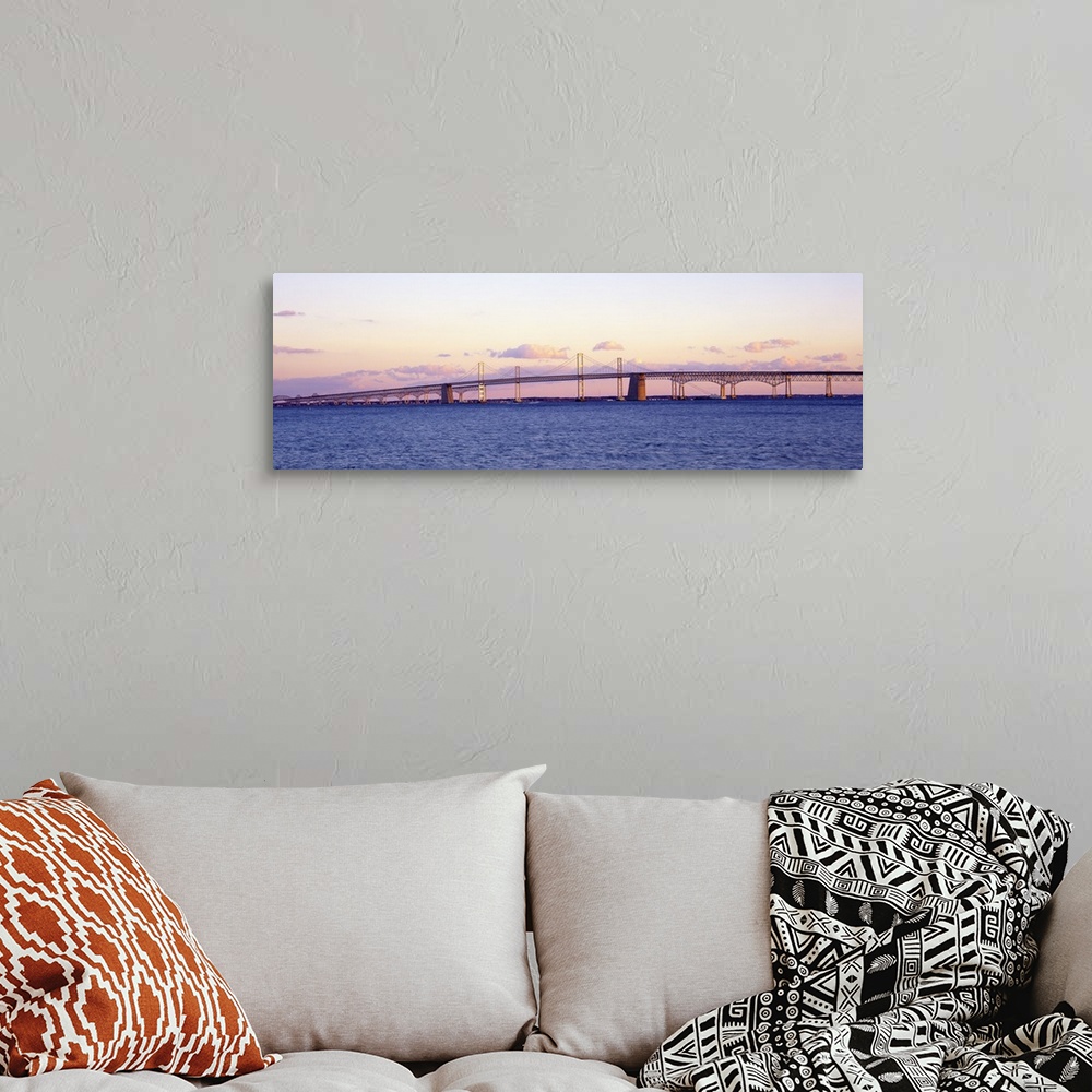 A bohemian room featuring This large panoramic shot is taken of the Chesapeake Bay Bridge during a sunset.