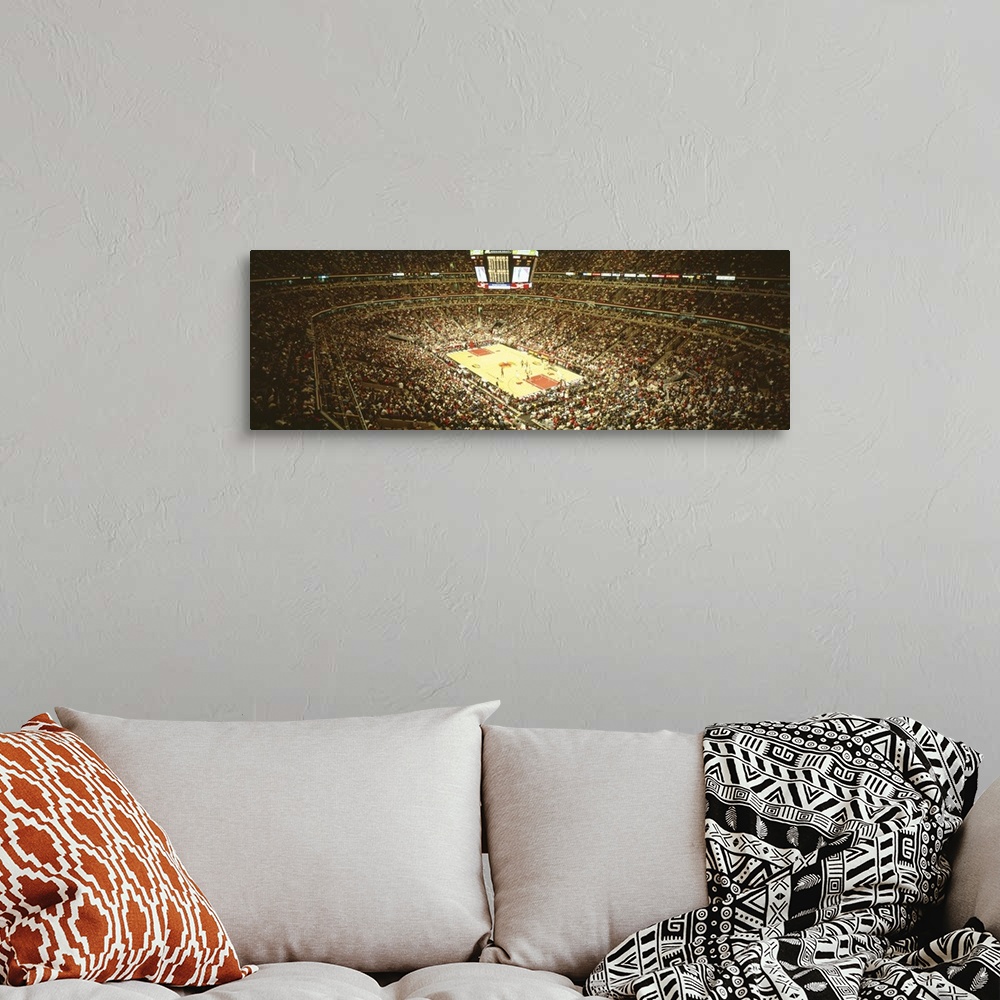 A bohemian room featuring A large panoramic photograph taken inside the Chicago Bulls stadium. The seats are filled with fa...