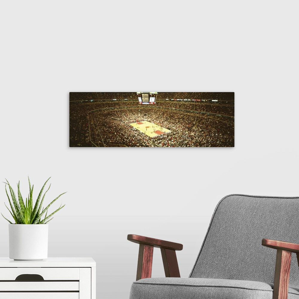 A modern room featuring A large panoramic photograph taken inside the Chicago Bulls stadium. The seats are filled with fa...