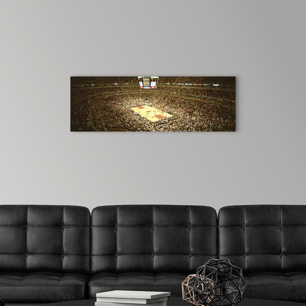 A modern room featuring A large panoramic photograph taken inside the Chicago Bulls stadium. The seats are filled with fa...