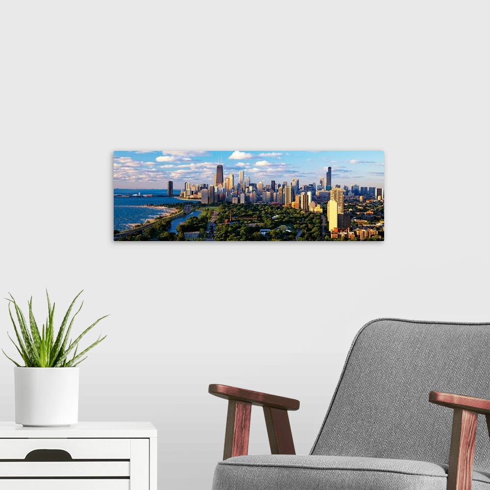 A modern room featuring Panoramic photograph taken of the busy skyline of Chicago, Illinois on a sunny day.  The skyscrap...
