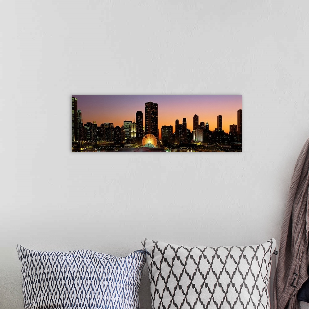 A bohemian room featuring The skyscrapers in Chicago have been silhouetted by the sunset but the windows are illuminated.