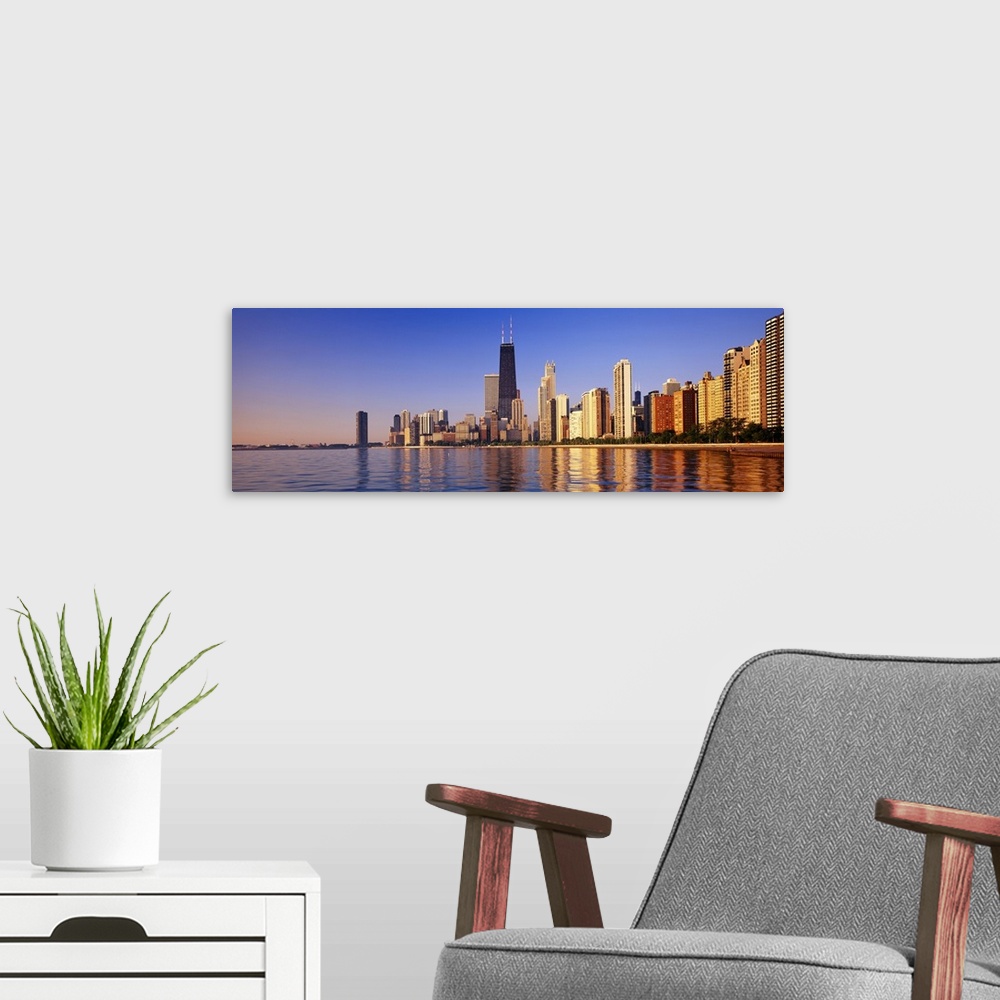 A modern room featuring Large panoramic view taken from the water of the Chicago skyline with the sears tower highlighted...