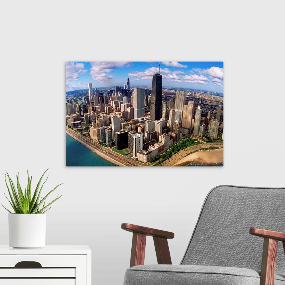 A modern room featuring A high angle landscape photograph viewing downtown Chicago taken from over Lake Michigan.