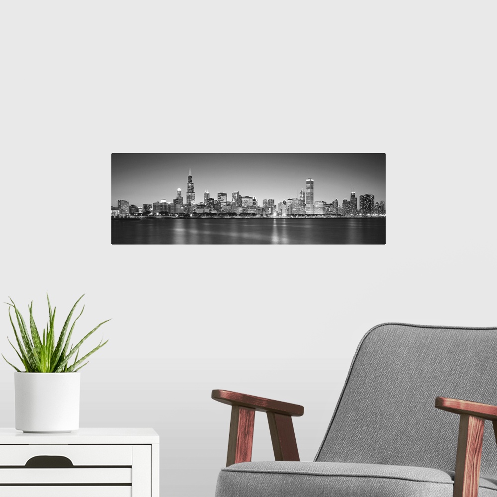 A modern room featuring Panoramic monochromatic photograph showcases the busy skyline of a famous city within the Midwest...