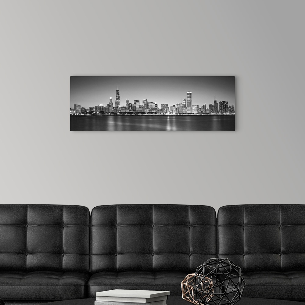 A modern room featuring Panoramic monochromatic photograph showcases the busy skyline of a famous city within the Midwest...