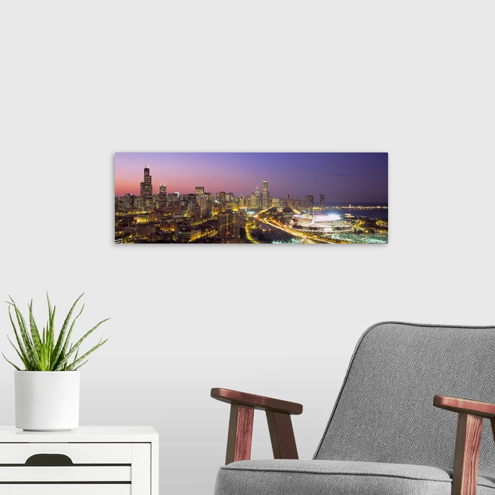 A modern room featuring Panoramic photograph captures the intensely bright lights of the busy streets and skyscrapers tha...