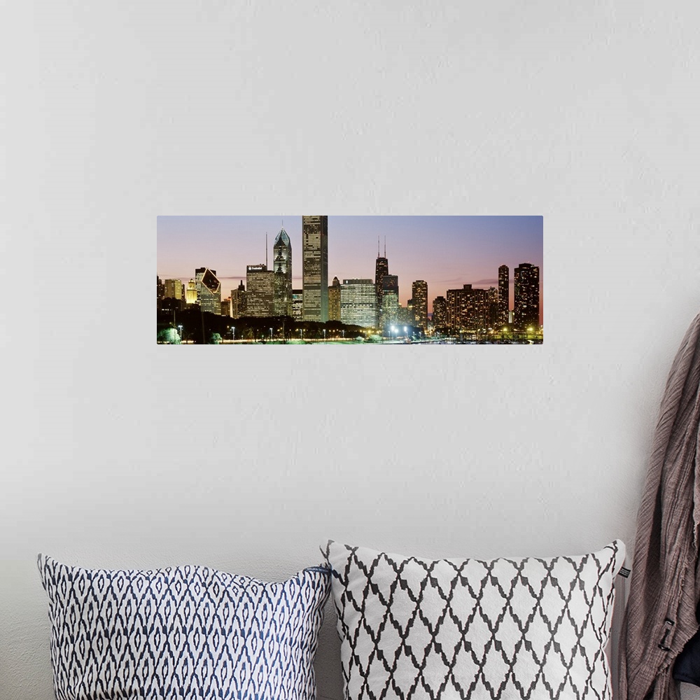 A bohemian room featuring Panoramic print of a cityscape illuminated at dusk along a waterfront.