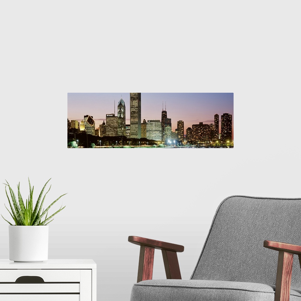 A modern room featuring Panoramic print of a cityscape illuminated at dusk along a waterfront.