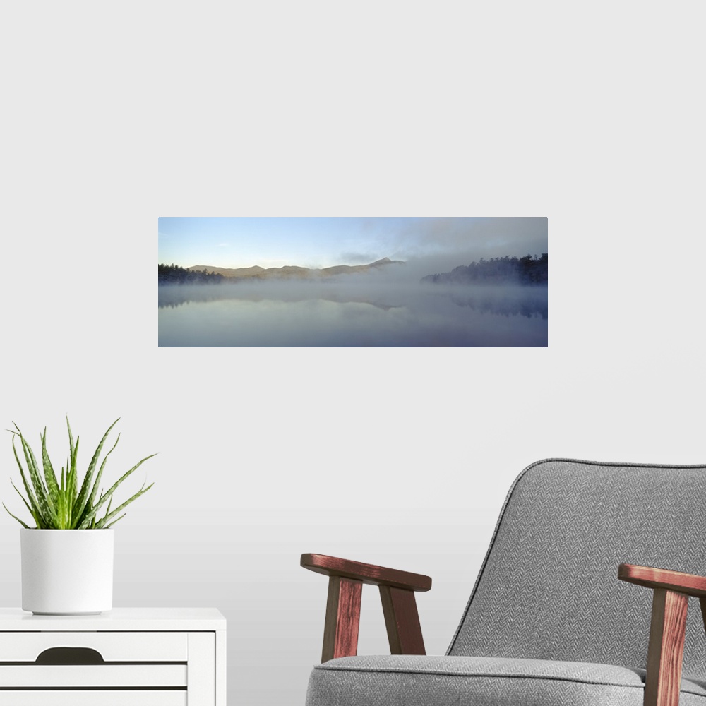 A modern room featuring Wall art for the home or office this panoramic photograph shows mist rising off a New England lake.