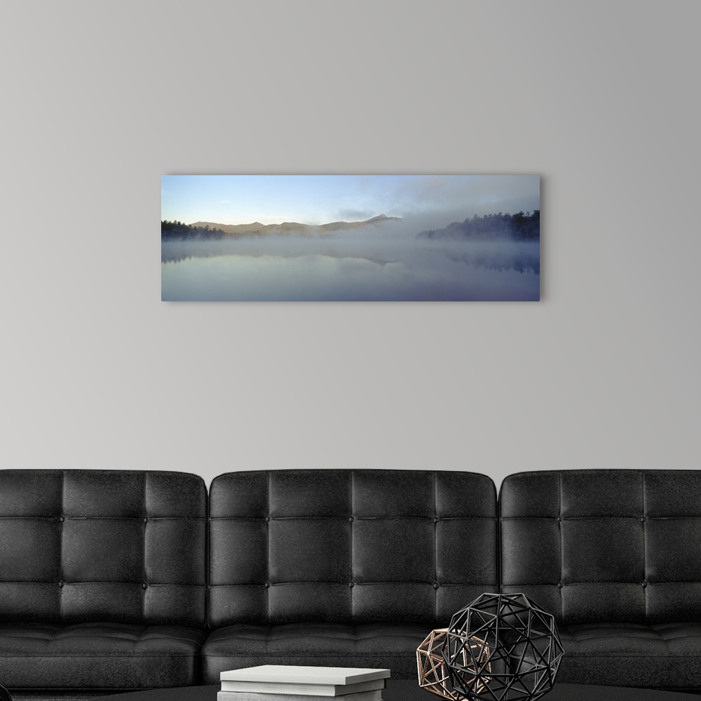 A modern room featuring Wall art for the home or office this panoramic photograph shows mist rising off a New England lake.