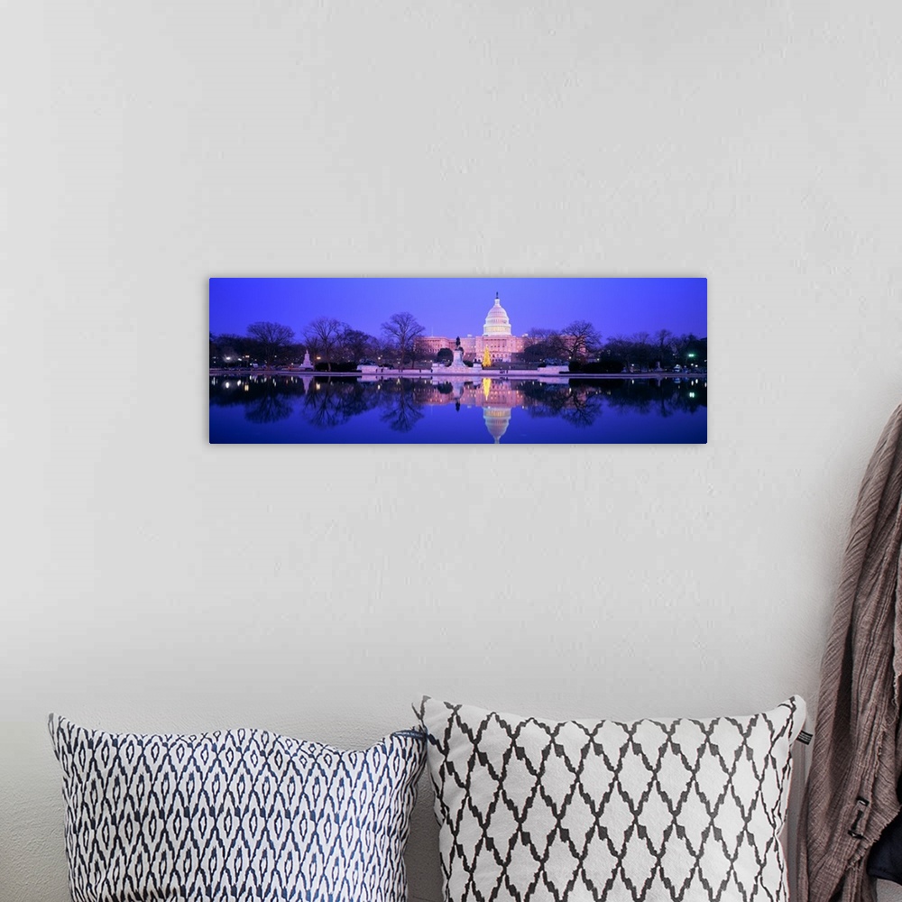 A bohemian room featuring A large panoramic photograph of the US Capitol building lit up during the night. The building and...