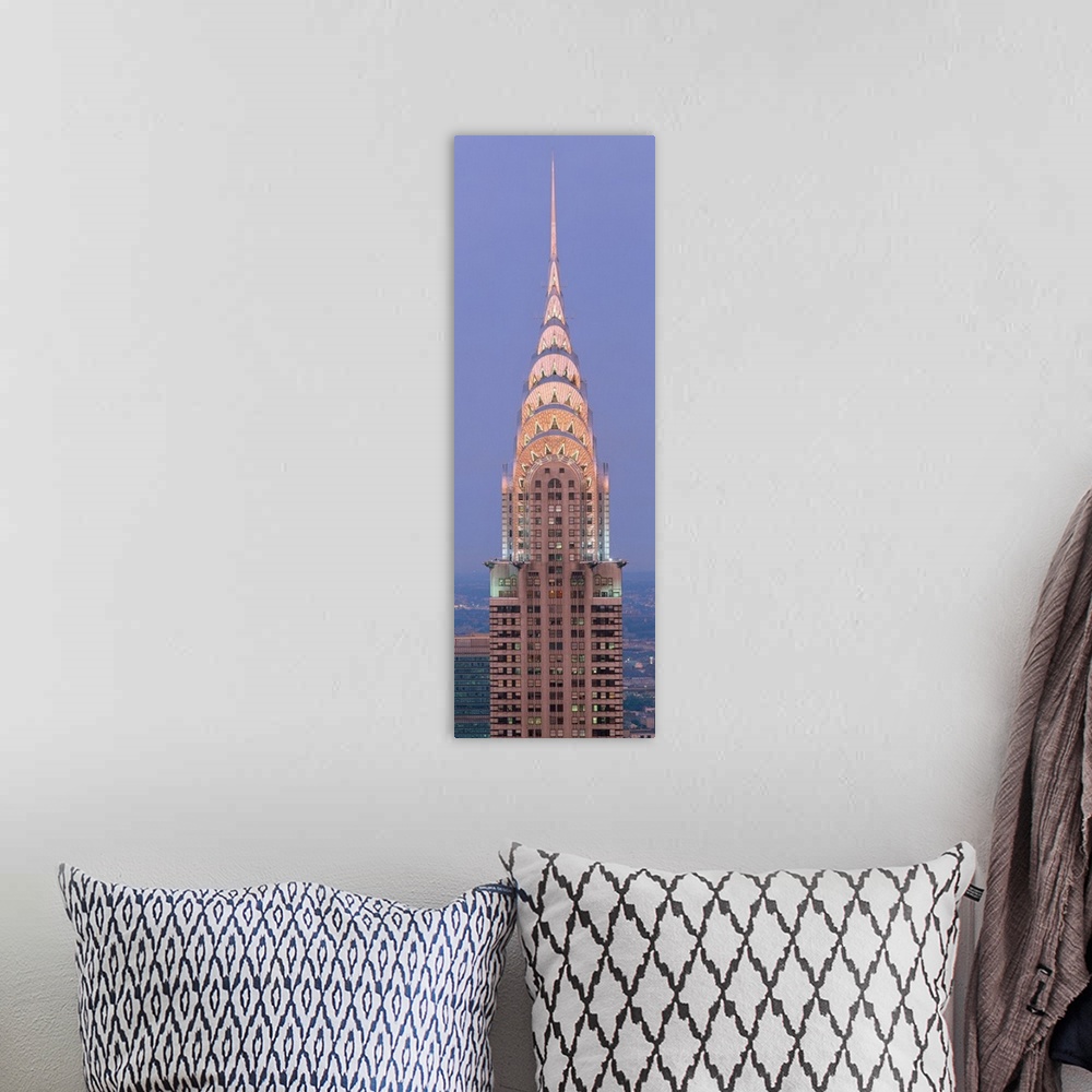 A bohemian room featuring Lit up spire and top floors of the Chrysler building at dusk.