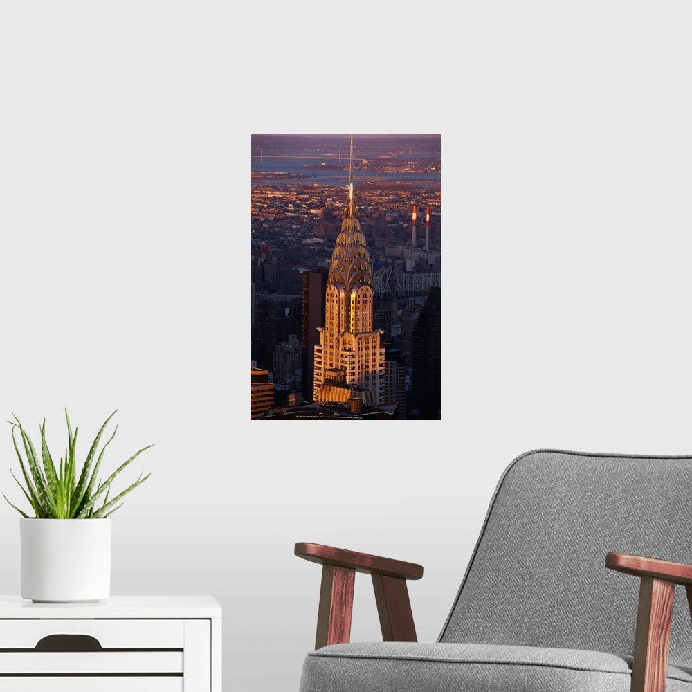 A modern room featuring Vertical, large aerial photograph of the Chrysler Building in the sunlight, in New York City.