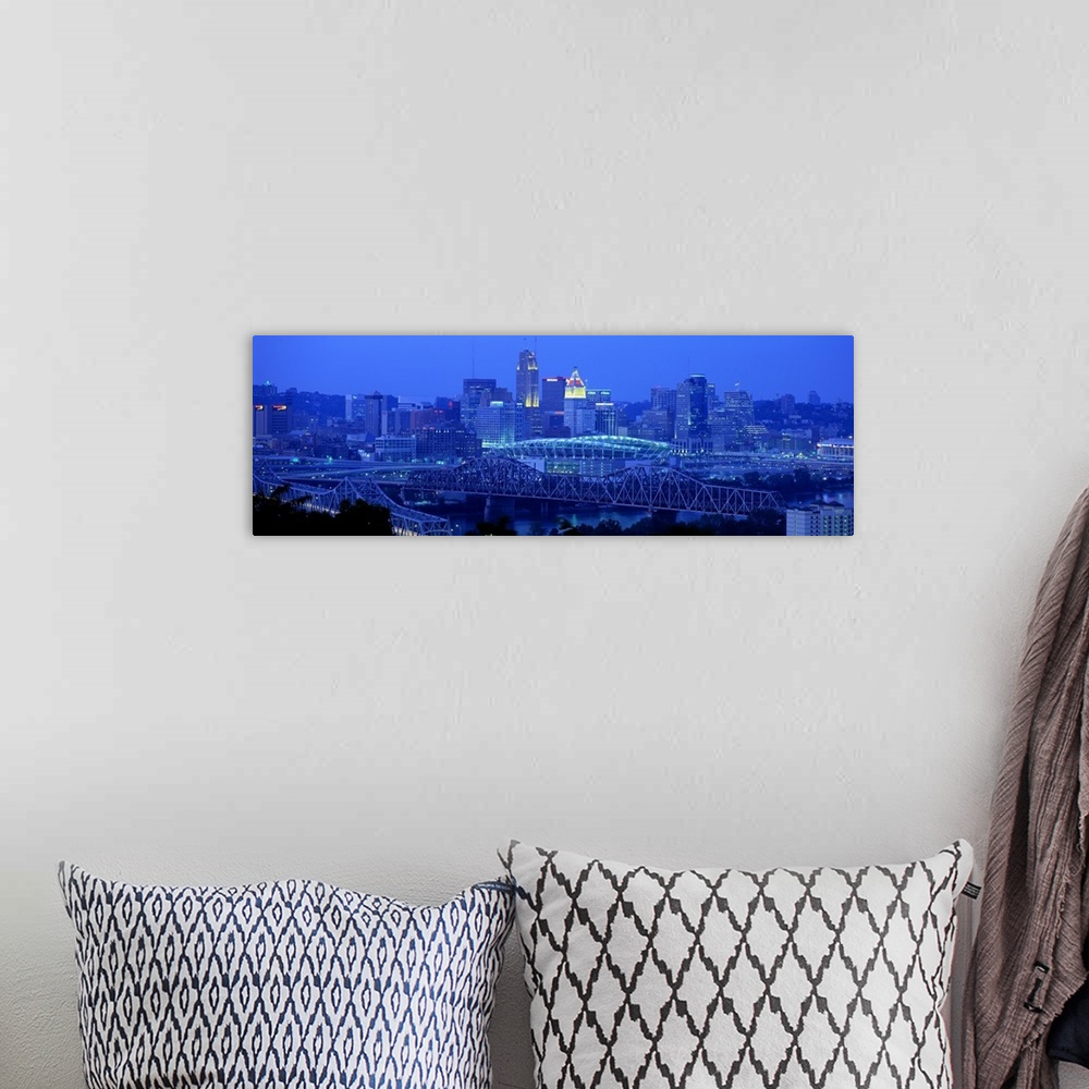 A bohemian room featuring Panoramic photograph of downtown  Cincinnati skyline at night and bridges over the Ohio River.