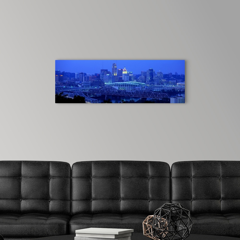 A modern room featuring Panoramic photograph of downtown  Cincinnati skyline at night and bridges over the Ohio River.