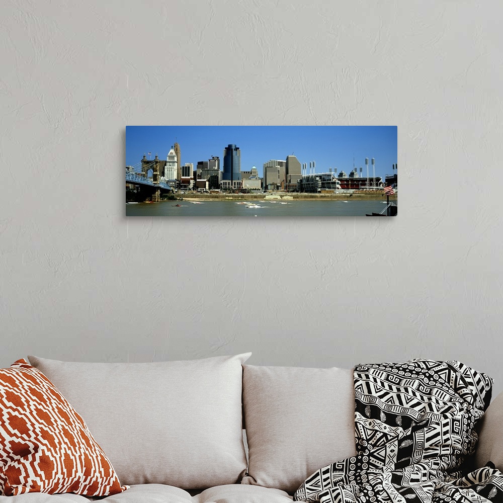 A bohemian room featuring Boats skimming along the Ohio River with downtown Cincinnati in the background.