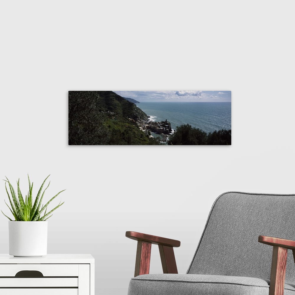 A modern room featuring Panoramic image of an Italian cliff leading to a city by the ocean on canvas.