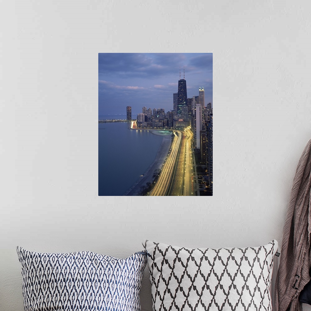 A bohemian room featuring Vertical panoramic photograph at dusk with city skyline in the distance and busy highway and stre...