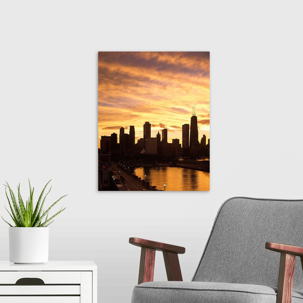 A modern room featuring Giant, vertical photograph of the Chicago skyline and Navy Pier beneath a golden sky of wispy clo...