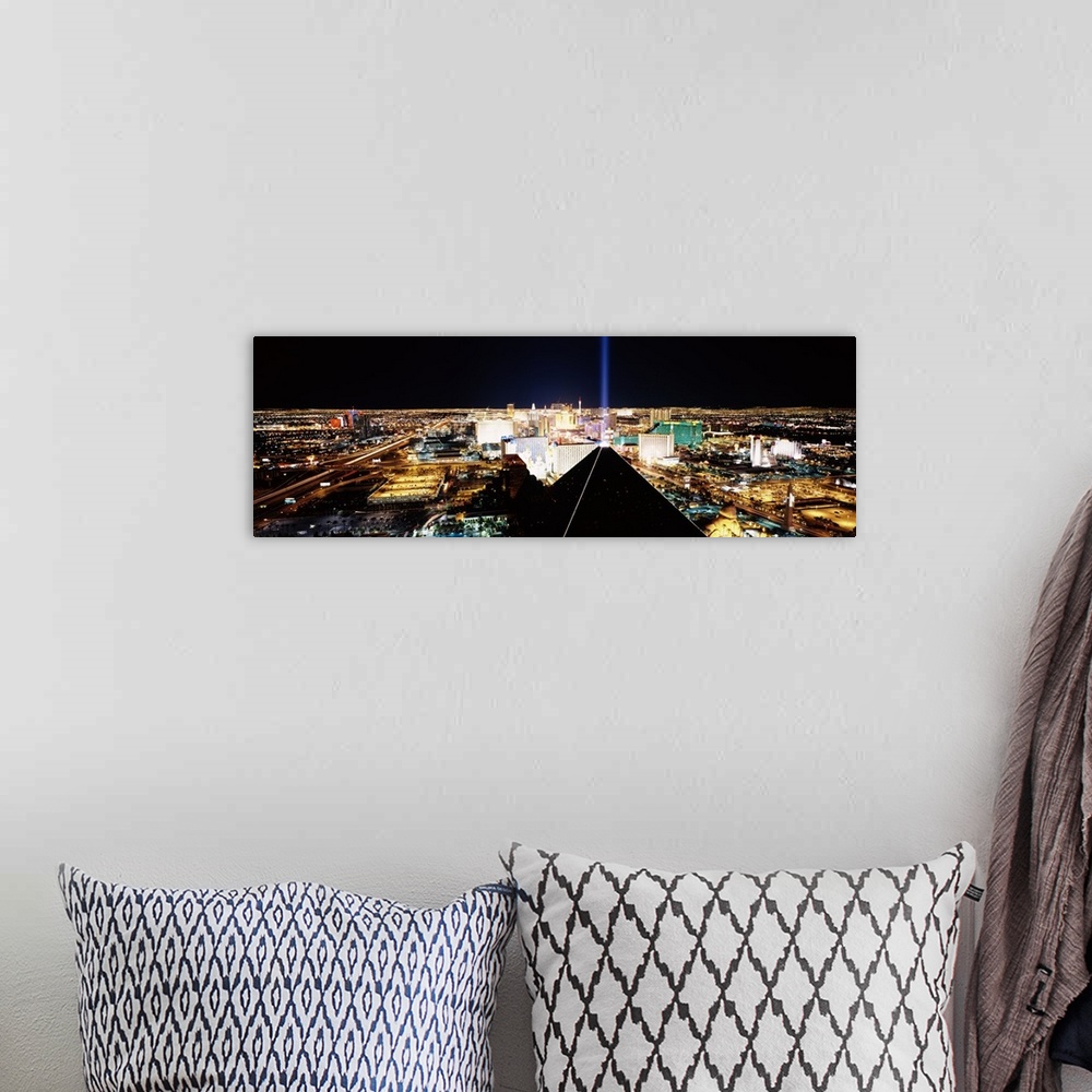 A bohemian room featuring Giant, wide angle landscape photograph of Las Vegas at night, taken looking downward from Mandala...