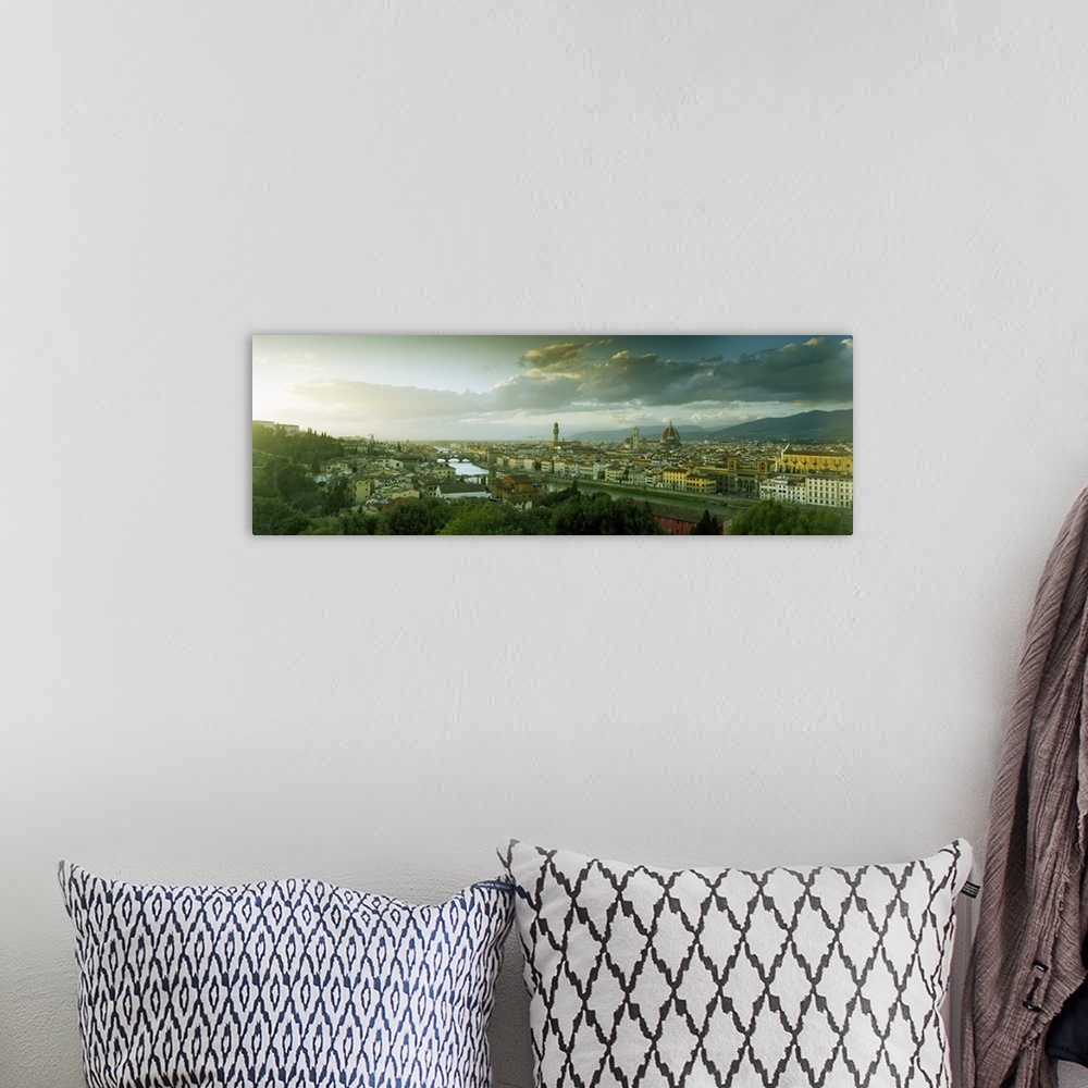 A bohemian room featuring Panoramic photograph taken from an aerial view overlooking a busy city within Europe.  In the dis...