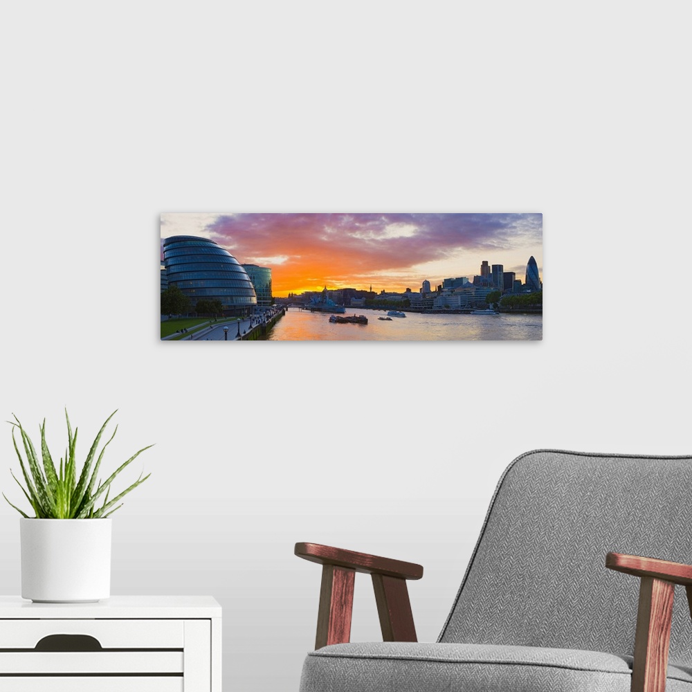A modern room featuring City hall with office buildings at sunset Thames River London England
