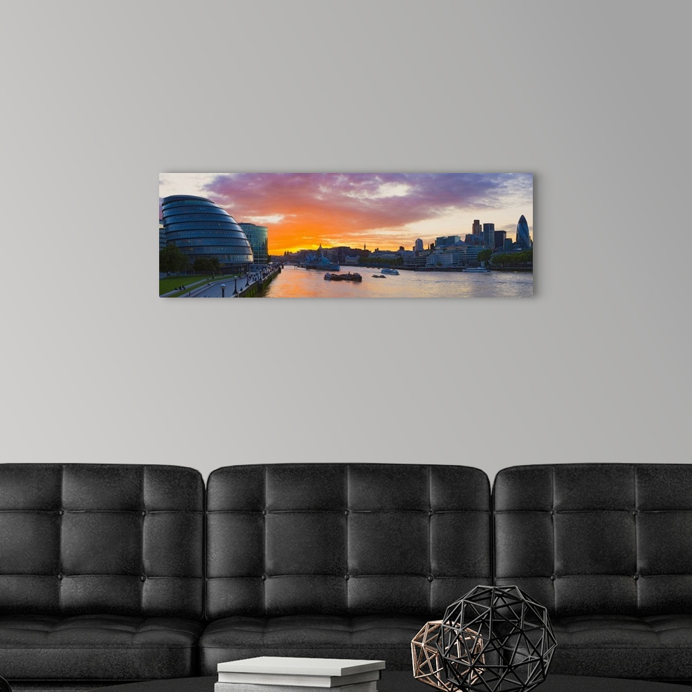 A modern room featuring City hall with office buildings at sunset Thames River London England