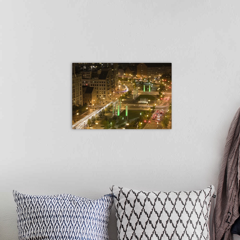 A bohemian room featuring A time lapsed photograph of busy metropolitan streets on either side of a hybrid park and median ...