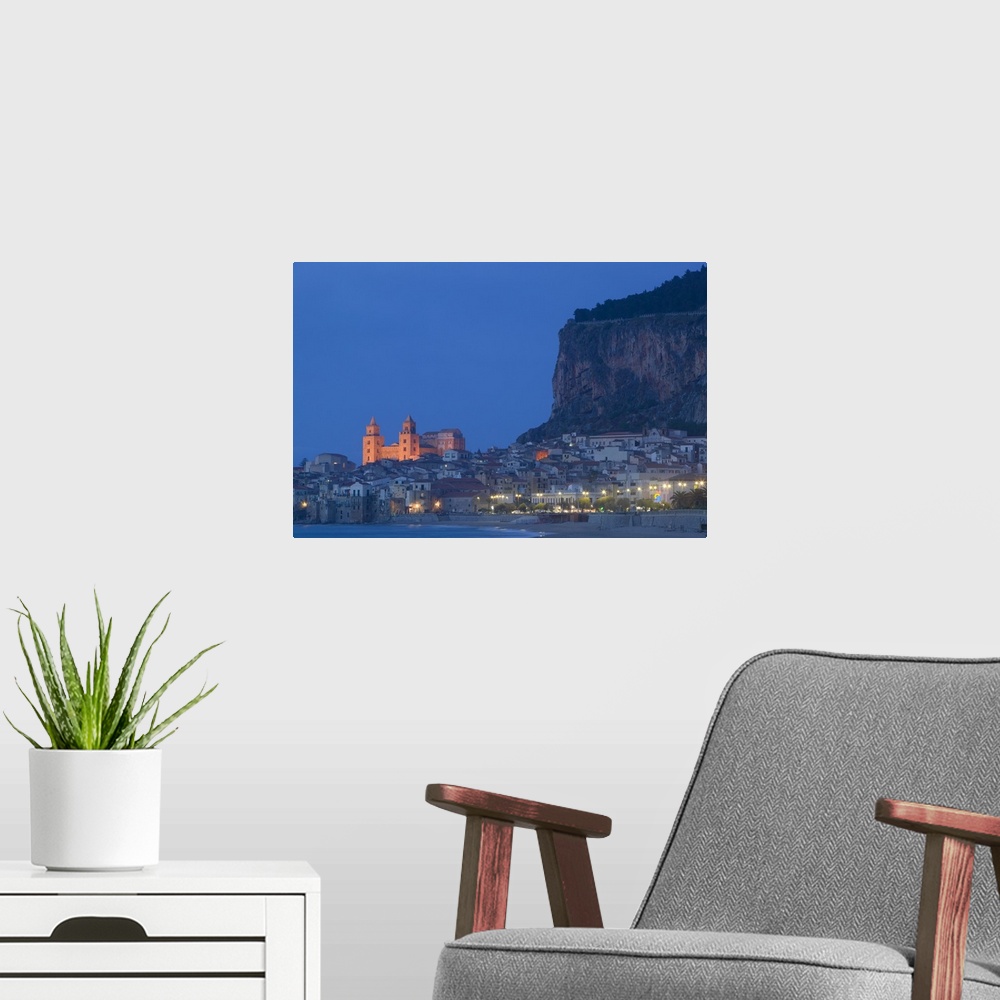 A modern room featuring Large photograph includes a lively town on the coast of this famous island in Europe brightly shi...