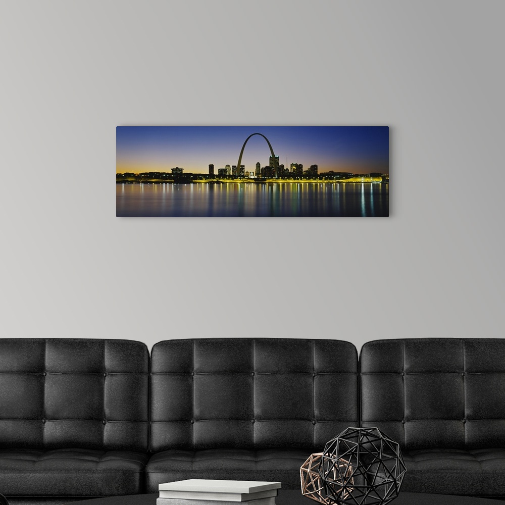A modern room featuring Panoramic photograph of skyline featuring the St. Louis Arch and waterfront at dusk.