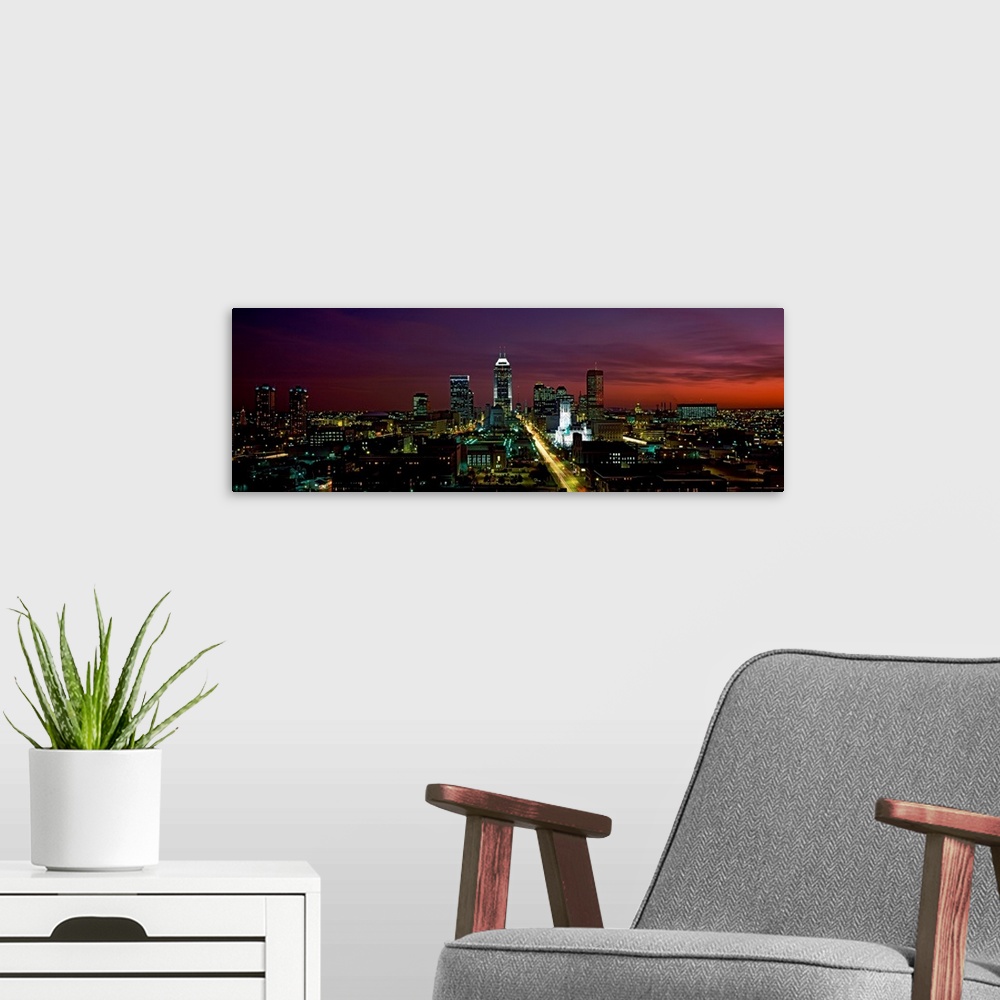 A modern room featuring A cityscape panoramic of captured in the fading evening light in this photograph.