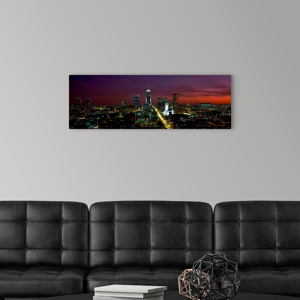 A modern room featuring A cityscape panoramic of captured in the fading evening light in this photograph.
