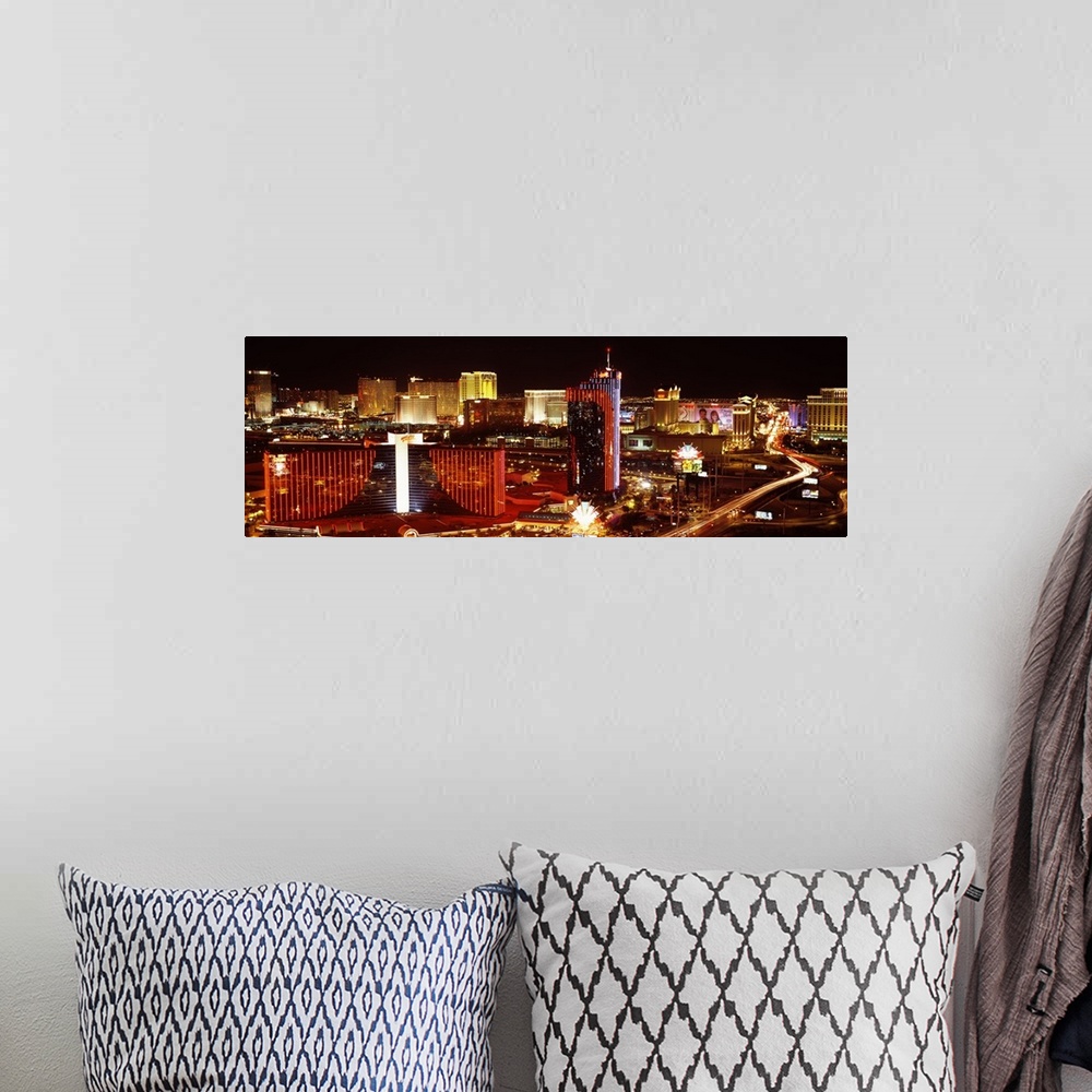 A bohemian room featuring Horizontal photograph on a big canvas of Las Vegas, Nevada, brightly lit at night.
