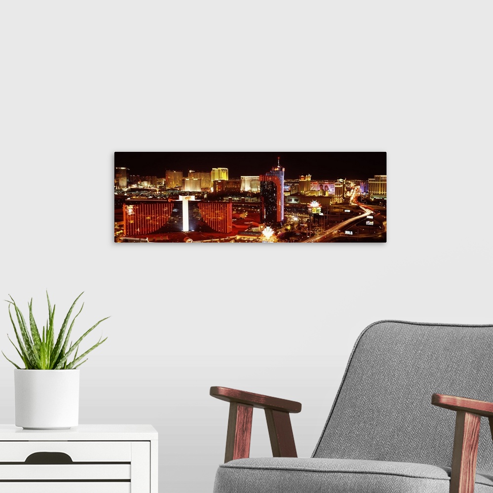 A modern room featuring Horizontal photograph on a big canvas of Las Vegas, Nevada, brightly lit at night.