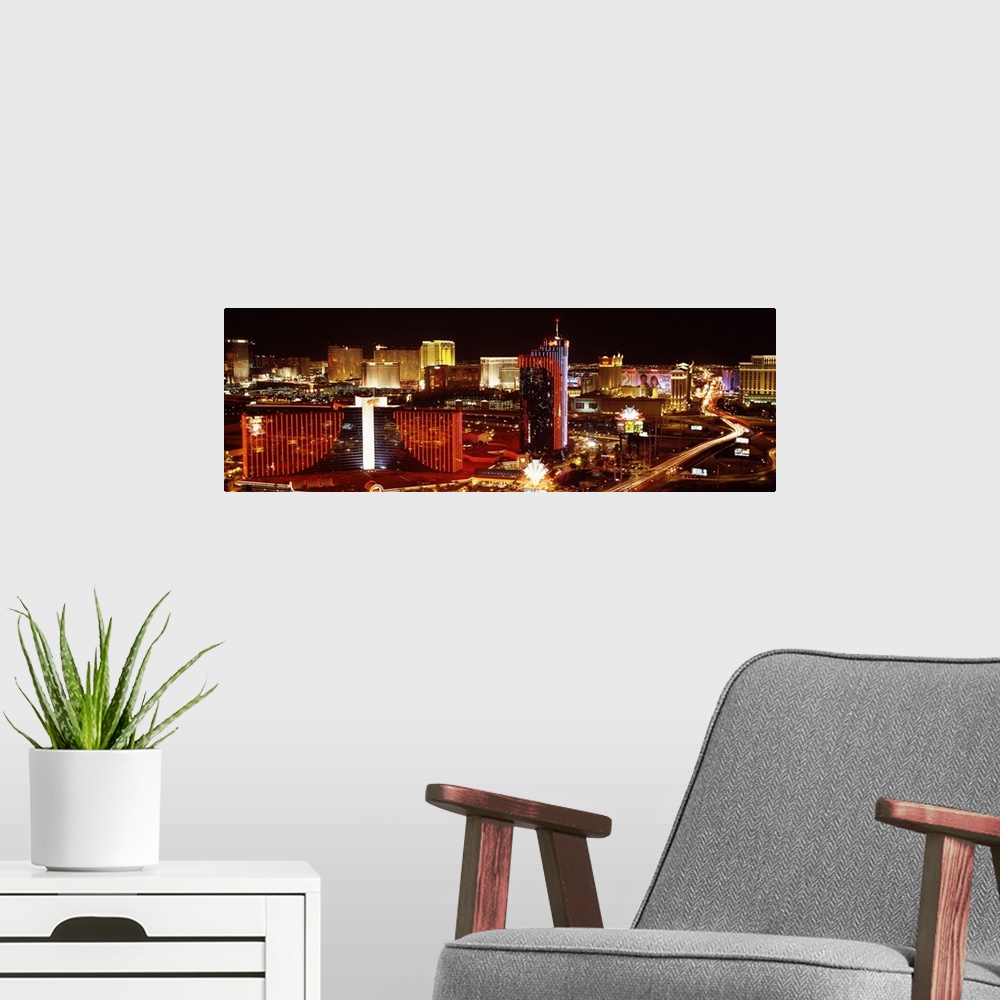 A modern room featuring Horizontal photograph on a big canvas of Las Vegas, Nevada, brightly lit at night.