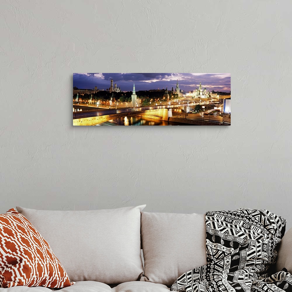 A bohemian room featuring Panoramic photograph of skyline and waterways at dusk under a dark cloudy sky.