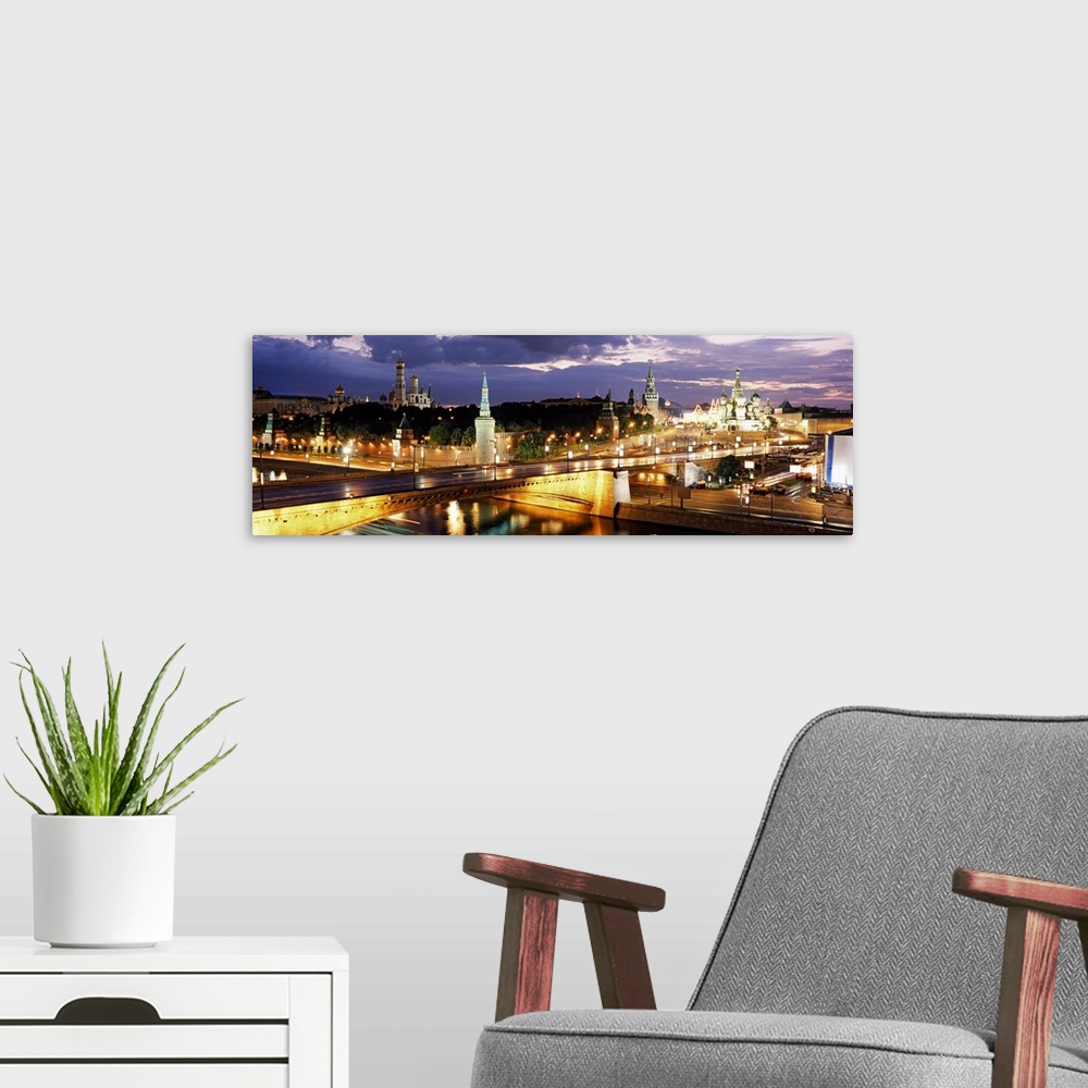 A modern room featuring Panoramic photograph of skyline and waterways at dusk under a dark cloudy sky.