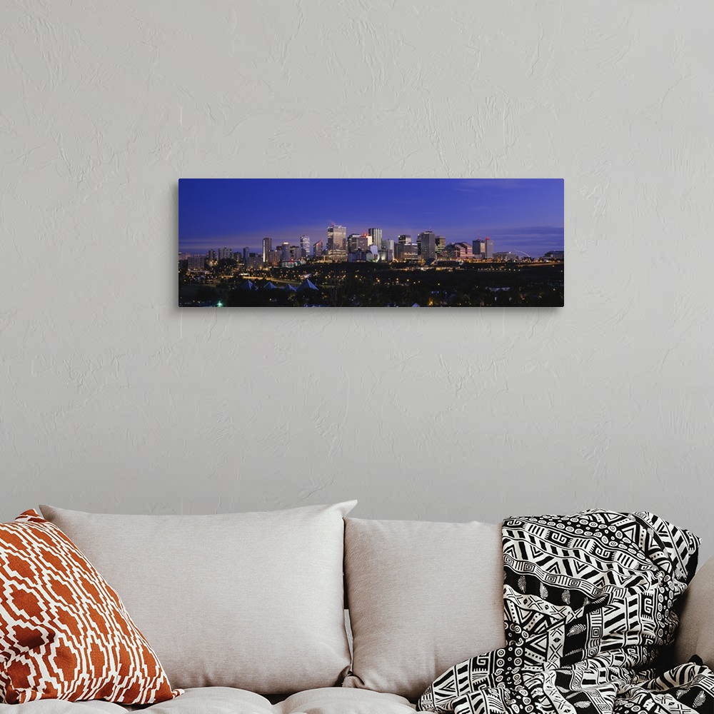 A bohemian room featuring Panoramic photograph of cityscape at dusk with buildings and skyscrapers lit up.