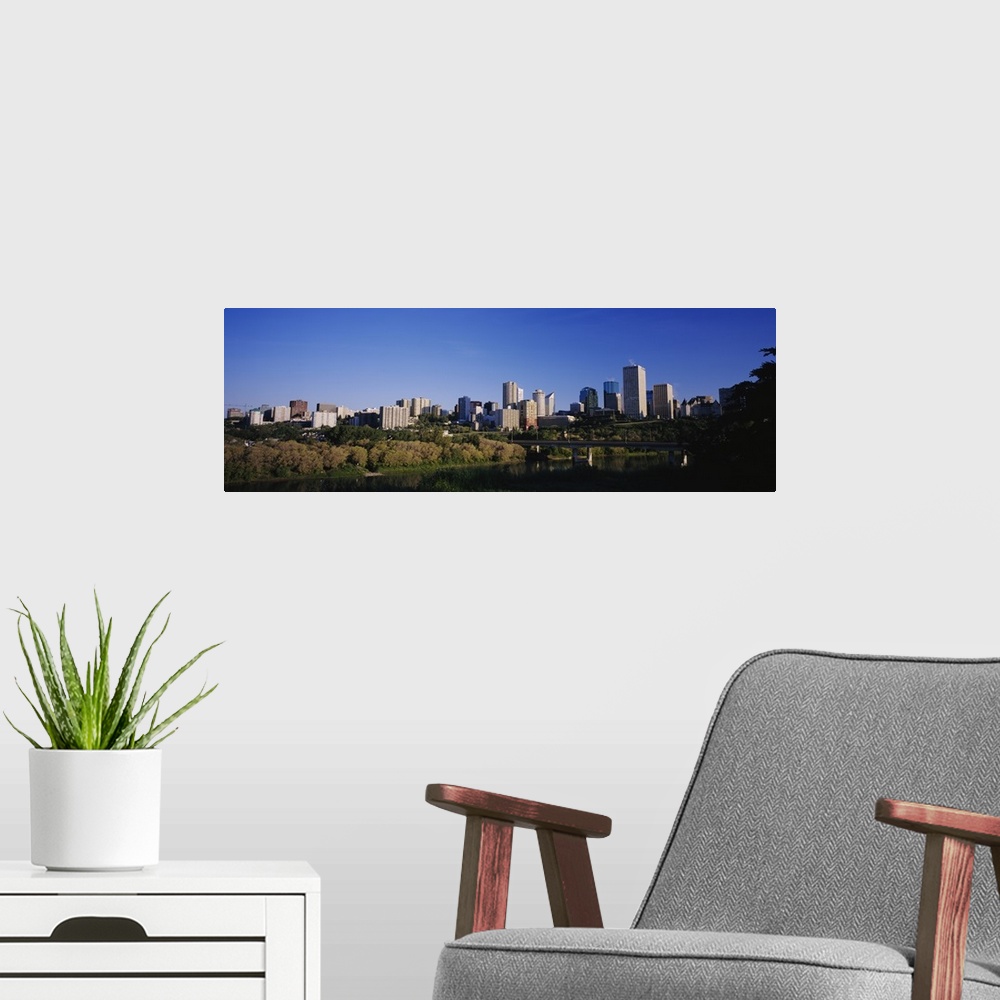A modern room featuring City skyline in front of a river, Edmonton, Alberta, Canada