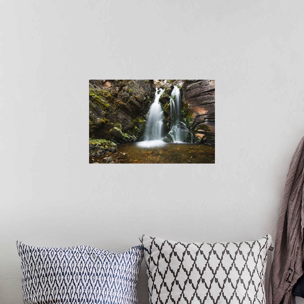 A bohemian room featuring Photo on canvas of water falling from a rocky cliff into a pool of water in Montana.