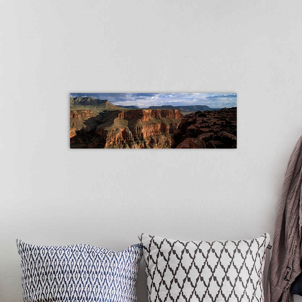 A bohemian room featuring Landscape of the Grand Canyon National Park in Arizona on a cloudy day.