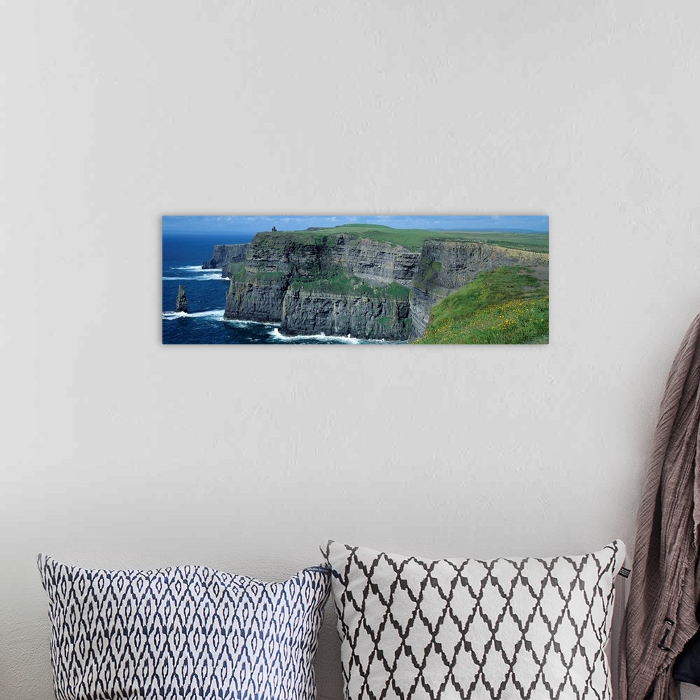 A bohemian room featuring Panoramic photograph of the Cliffs of Moher County Clare in Ireland on a sunny day.