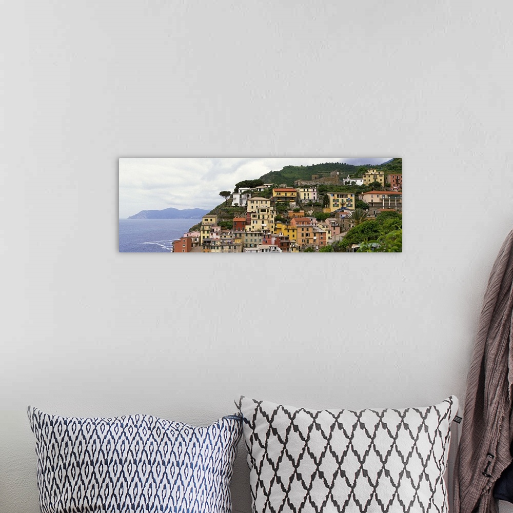 A bohemian room featuring This panoramic landscape photograph of homes built into the hillside overlooking the sea.